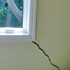 A long, diagonal crack that begins at a window corner of a Pomona home